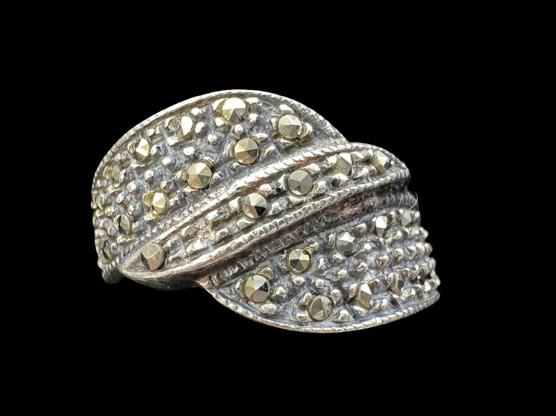 Ornate Vintage Sterling Silver & Marcasite Ring: Very good vintage condition with minor patina according to age. Measures approx. 5/8" wide and weighs ca. 3.7 grams. The ring is a size 8. Marked for Sterling Silver and carrying an unidentified desig