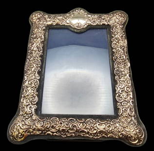 Vintage Sterling Silver Picture Frame: Very good vintage condition with minor wear according to age, please see pictures. Measures approx. 10 1/2" high and 8 1/2" wide.