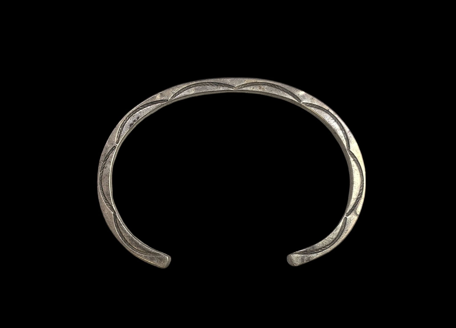 Solid Vintage Native American Navaho Sterling Silver Stampwork Bracelet: Very good vintage condition with minor patina and wear according to age. Measures approx. 3" wide and weighs ca. 27.5 grams. Marked and signed. SHIPPING: We ship in-house and charge a flat fee of $12