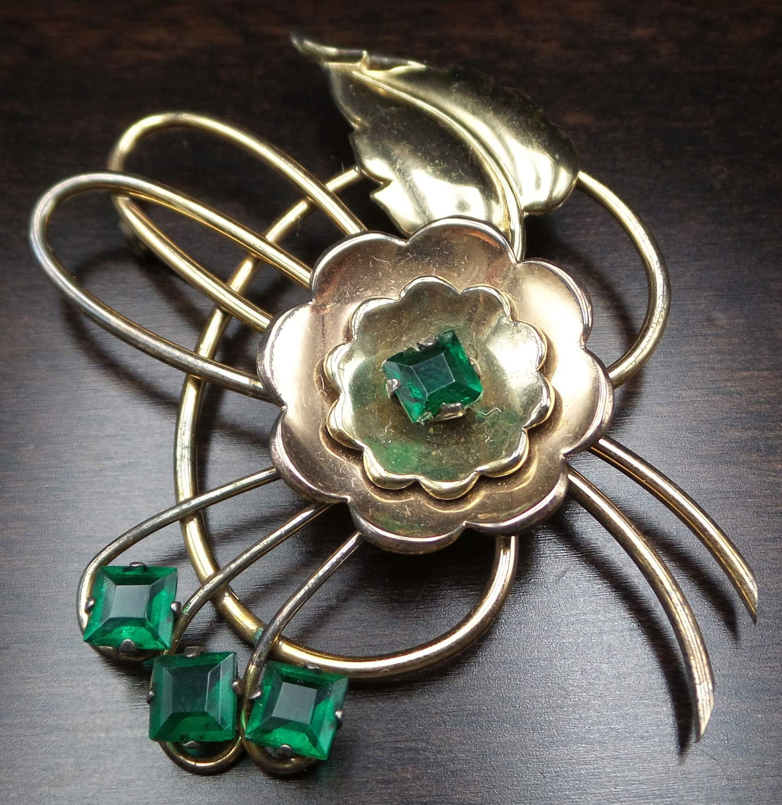 Vintage 1940s Art Deco HARRY ISKIN 10K Goldfilled Faux Emerald Flower Pin: Very unusual, large, and beautiful piece. Very good vintage condition. Measures approx. 2 3/4" long x 2 3/8" wide, and weighs ca. 19.1 grams. Designer mark on the bottom.
