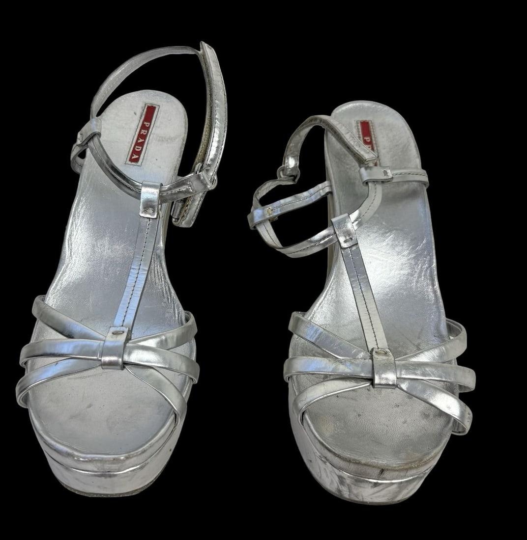 PRADA Metallic Silver Leather Slingback Wedge Hell Sandals - Previously Worn: PRADA Metallic Silver Leather Slingback Wedge Hell Sandals known for their sleek design featuring a pointed toe, a block heel. Good pre-loved condition; Previously Worn. Some signs of wear from use an