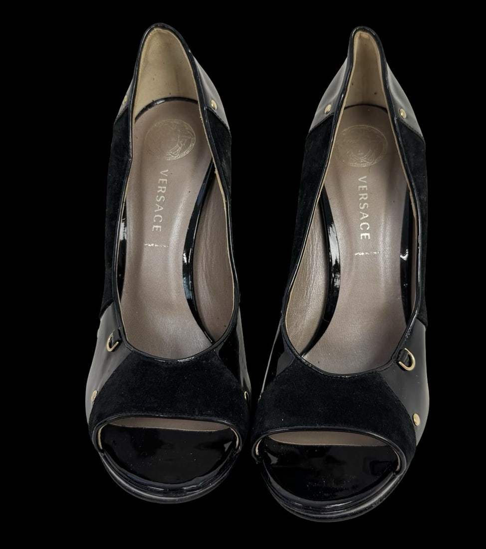 VERSACE Black Leather Heels - Never Worn: VERSACE Black Leather Heels known for their sleek design featuring and high heels. Very good pre-loved condition; never worn. Minimal signs of wear from storage. Size 40 1/2.