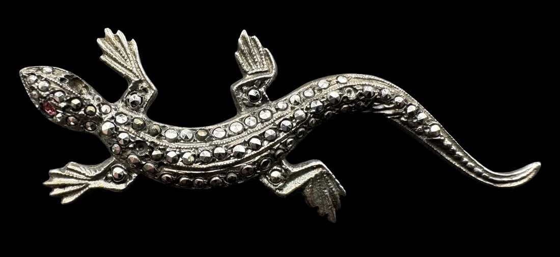 Vintage Sterling Silver & Marcasite Lizard Brooch /w Red Gemstone Eyes: Very good vintage condition with minor patina according to age. Measures approx. 1 7/8" long x 5/8" wide and weighs ca. 3.8 grams. Tested for Sterling Silver. Missing some Marcasites and one Eye.