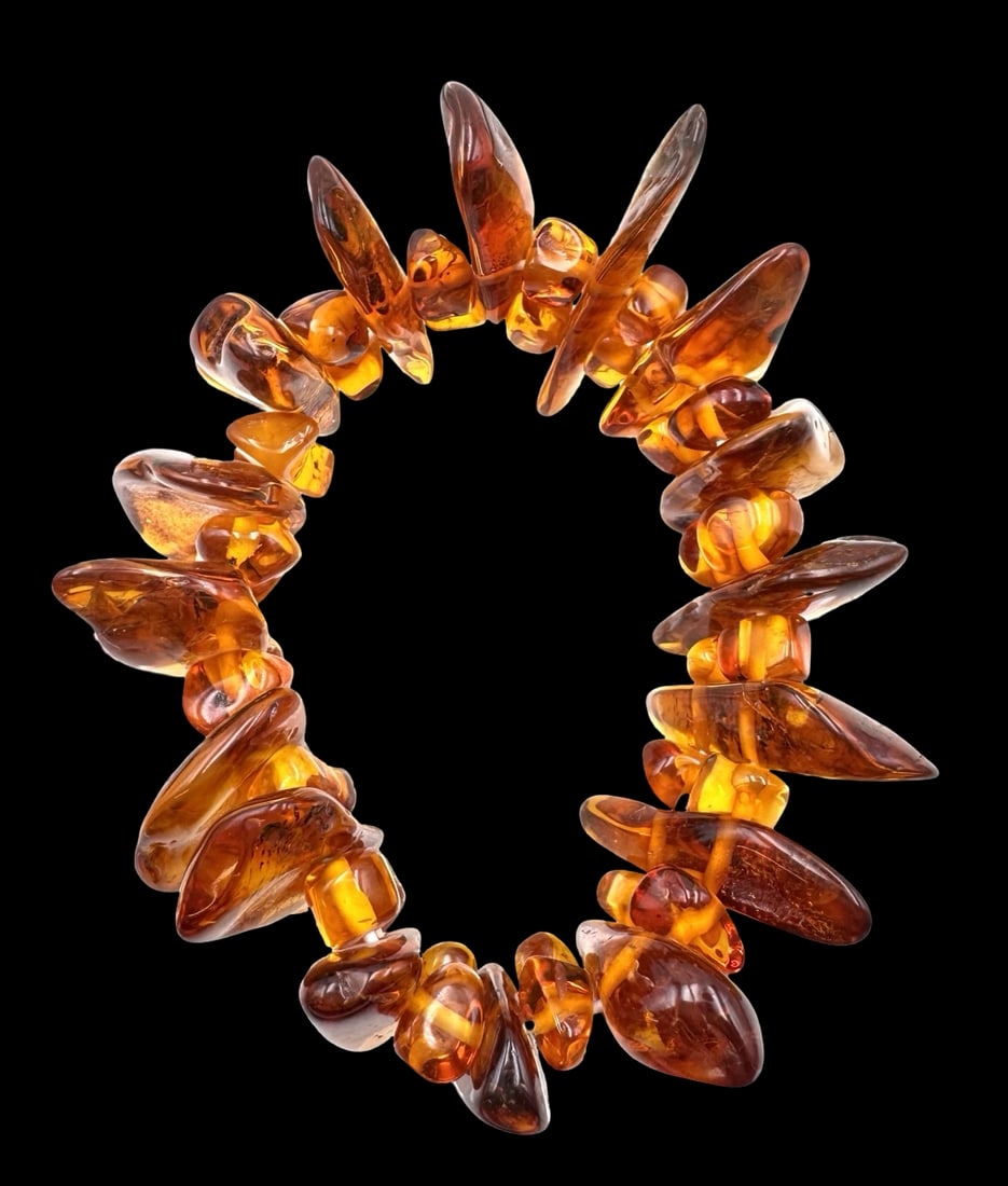 Vintage Baltic Amber Bracelet: Very good vintage condition with minor patina according to age. Measures approx. 6" (inside diameter) and 1 3/4" wide (largest piece). The bracelet is elastic. SHIPPING: We ship in-house and charge a