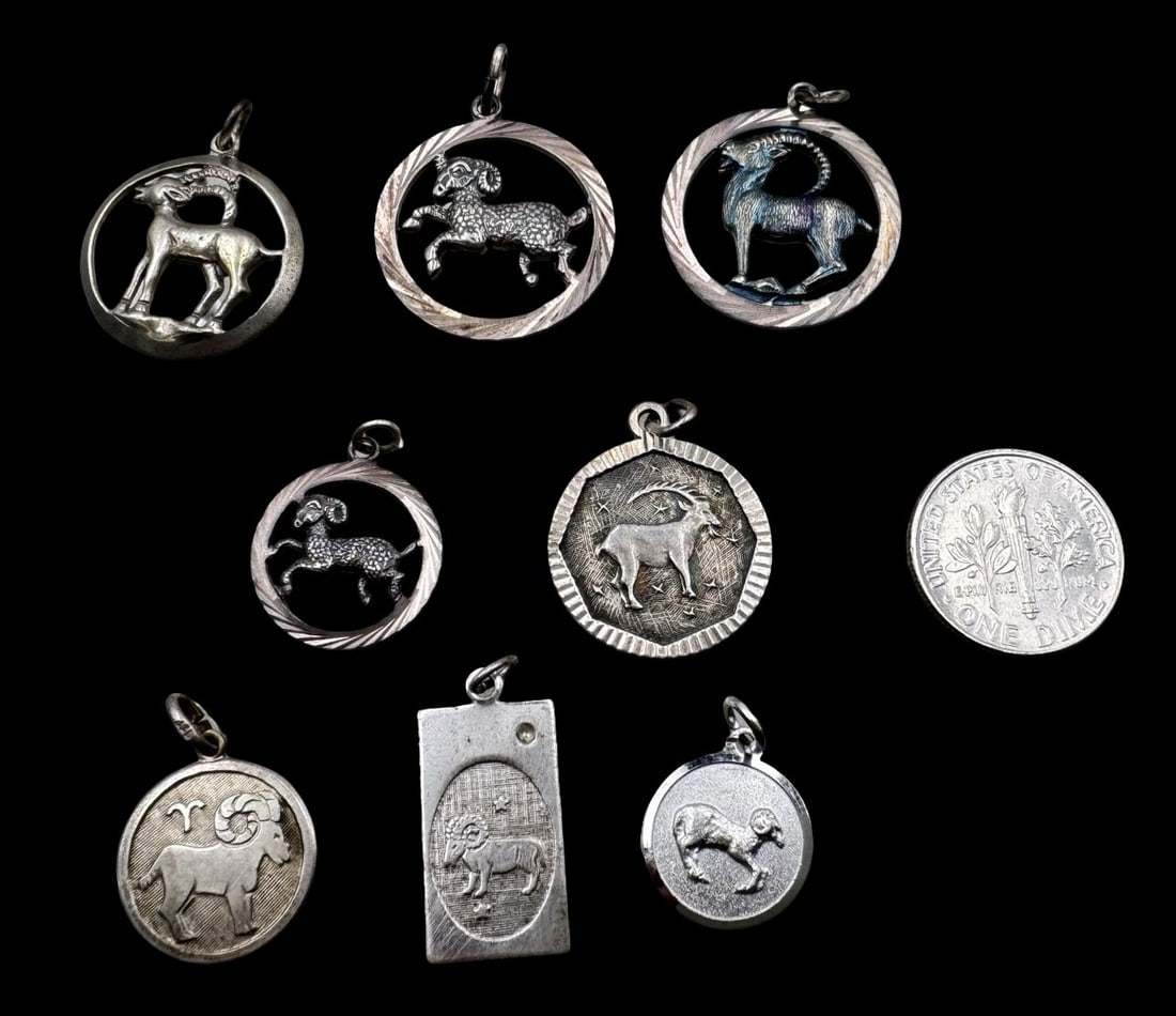Lot of 8 Vintage Sterling Silver Zodiac Sign Pendant Charms - Capricorn: Very good vintage condition with minor patina according to age. The largest measures approx. 3/4" in diameter and they jointly weigh ca. 13.9 grams. Marked for Sterling Silver. SHIPPING: We ship in-ho
