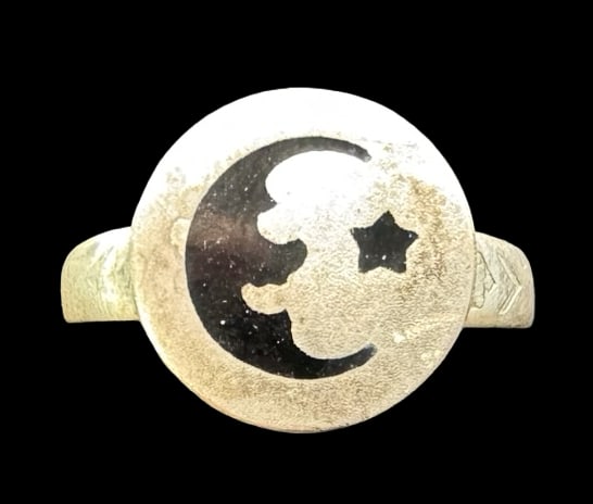 Unusual Vintage Sterling Silver & Black Enamel Moon and Star Ring: Very good vintage condition with minor patina according to age. Measures approx. 1/2" in diameter and weighs ca. 2.1 grams. The Ring is Size 7. Tested for Sterling Silver.