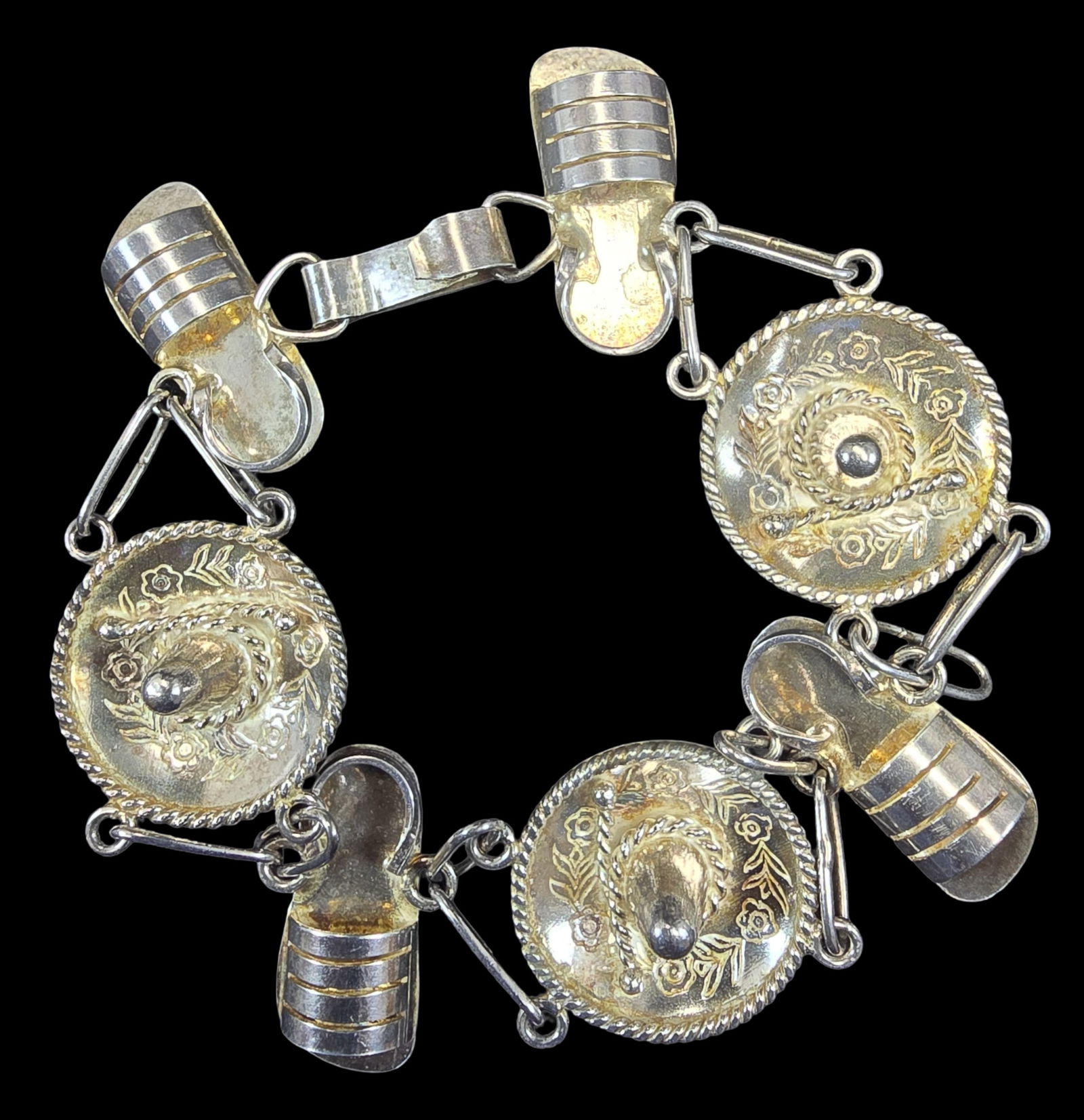 Whimsical Vintage Mexican Sterling Silver Somrero & Sandal Bracelet: Very good vintage condition with minor patina according to age. Measures approx. 7" long and weighs ca. 23 grams. Marked.