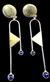 Long arch goldtone dangle earrings with bluestone