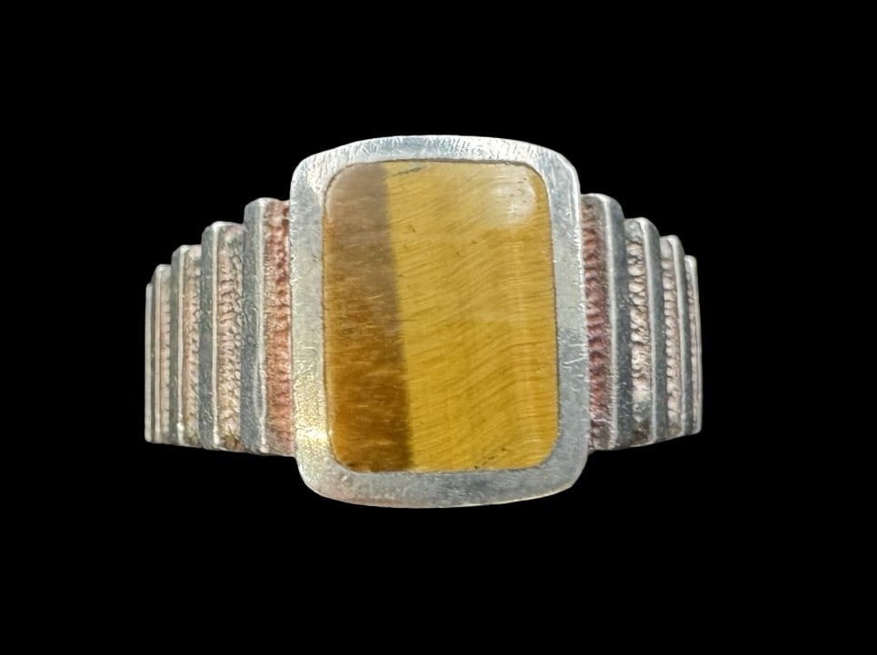 Vintage Mid-Century Sterling Silver & Tiger Eye Ring: Very good vintage condition with minor patina according to age. The gemstone measures approx. 1/2" wide and weighs ca. 5.7 grams. The ring is a size 9.5. Marked for Sterling Silver.