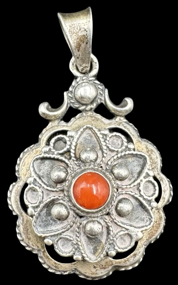 Ornate Vintage Sterling Silver & Red Coral Pendant: Very good vintage condition with minor patina according to age. Measures approx. 1 1/2" long x 7/8" wide and weighs ca. 4.5 grams. Marked for Sterling Silver.