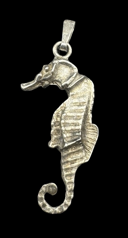 Whimsical Vintage Sterling Silver Seahorse Pendant: Very good vintage condition with minor patina according to age. Measures approx. 1 1/4" long x 1/2" wide and weighs ca. 2.2 grams. Marked for Sterling Silver.