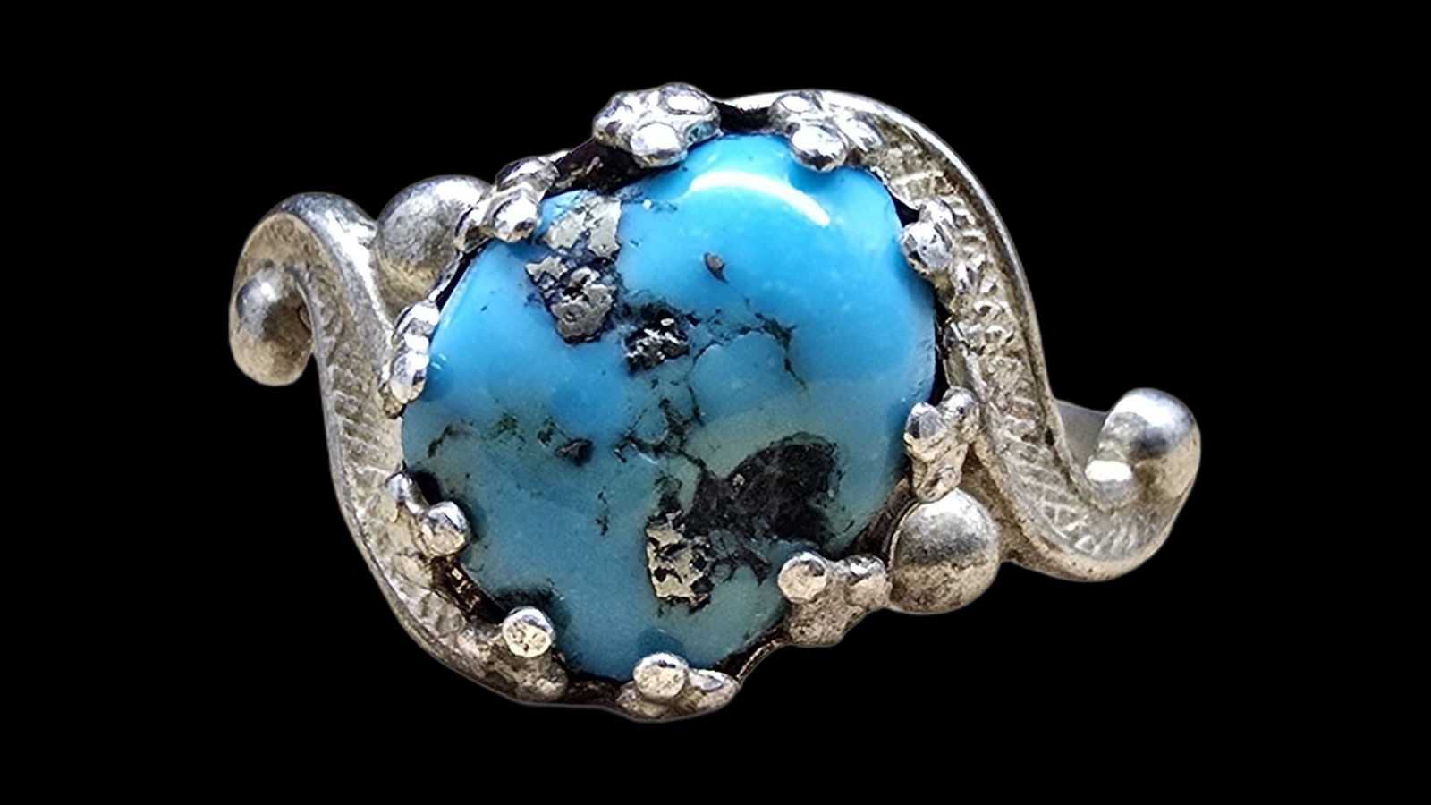 Mid-Century Southwestern Sterling Silver & Turquoise Ring: Very good vintage condition with minor patina according to age. The ring is a size 6.5 and weighs ca. 2.5 grams. Marked for Sterling Silver.