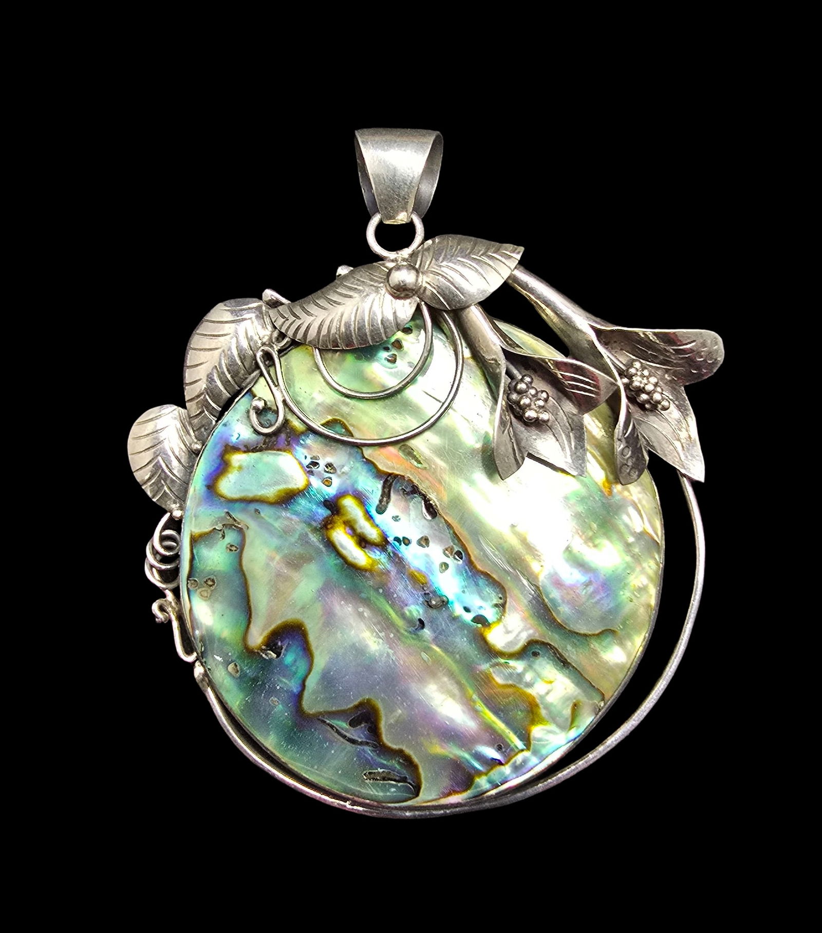 Large & Ornate Vintage Sterling Silver & Mother of Pearl Pendant: Very good vintage condition with minor patina according to age. Measures approx. 3 " long x 2 1/2" wide and weighs ca. 27 grams. Marked for Sterling Silver.