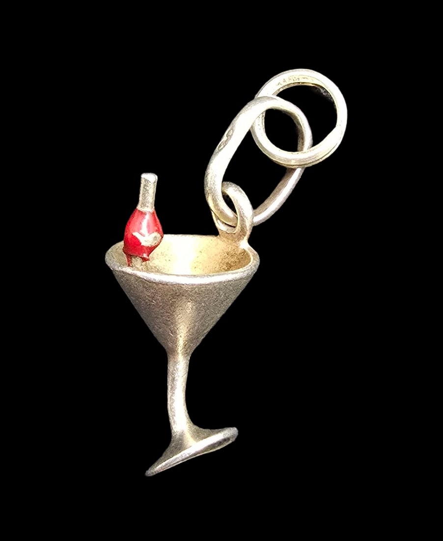 Whimsical Vintage Sterling Silver Cocktail Glass /w Cherry Pendant Charm: Very good vintage condition with minor patina according to age. Measures approx. 1" long and weighs ca. 2.5 grams. Marked for Sterling Silver.