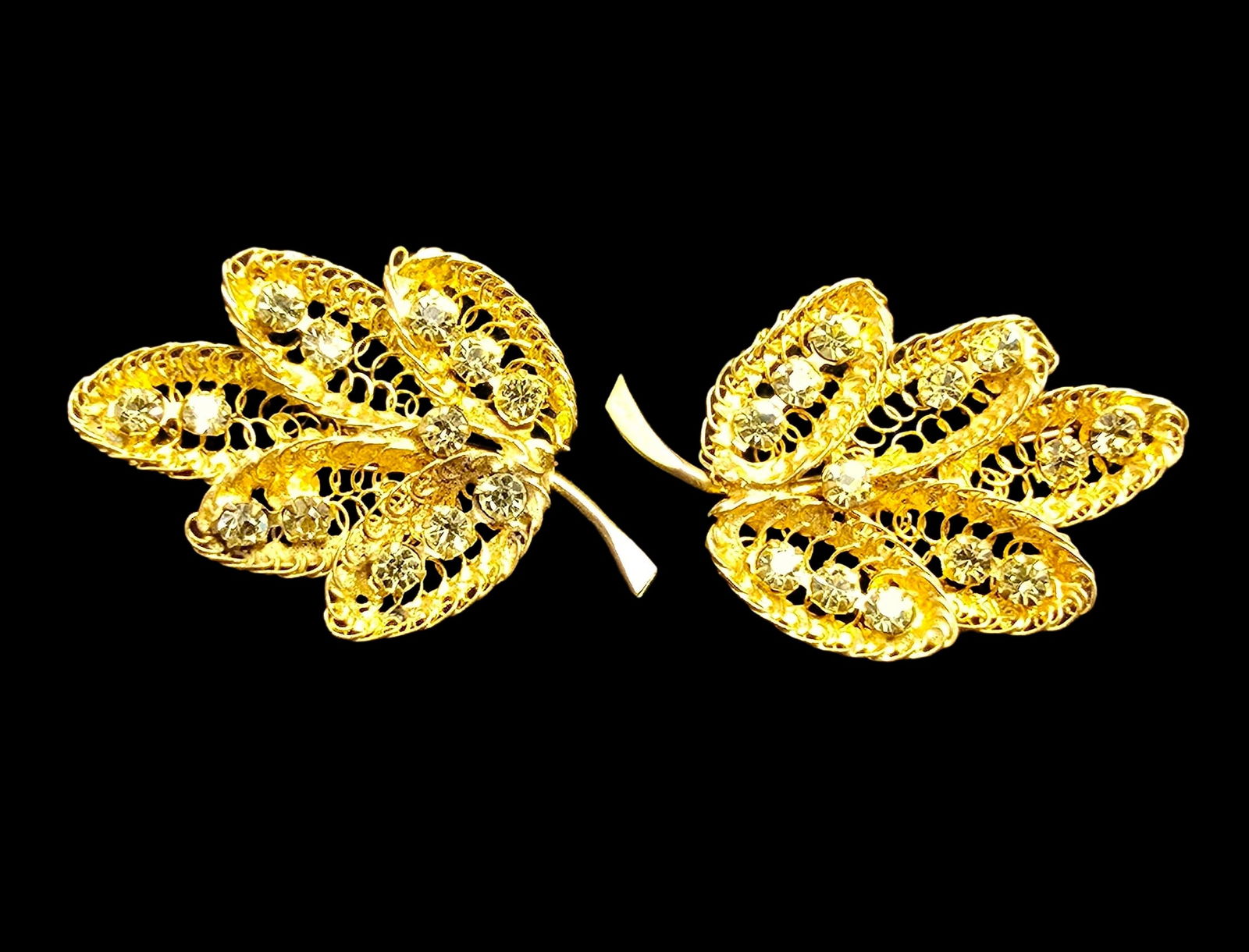 Pair of Vintage Gold-Tone Metal & Clear Gemstone Leaf Brooches: Very good vintage condition with minor patina according to age. Each measures approx. 2" long and they jointly weigh ca. 13 grams.