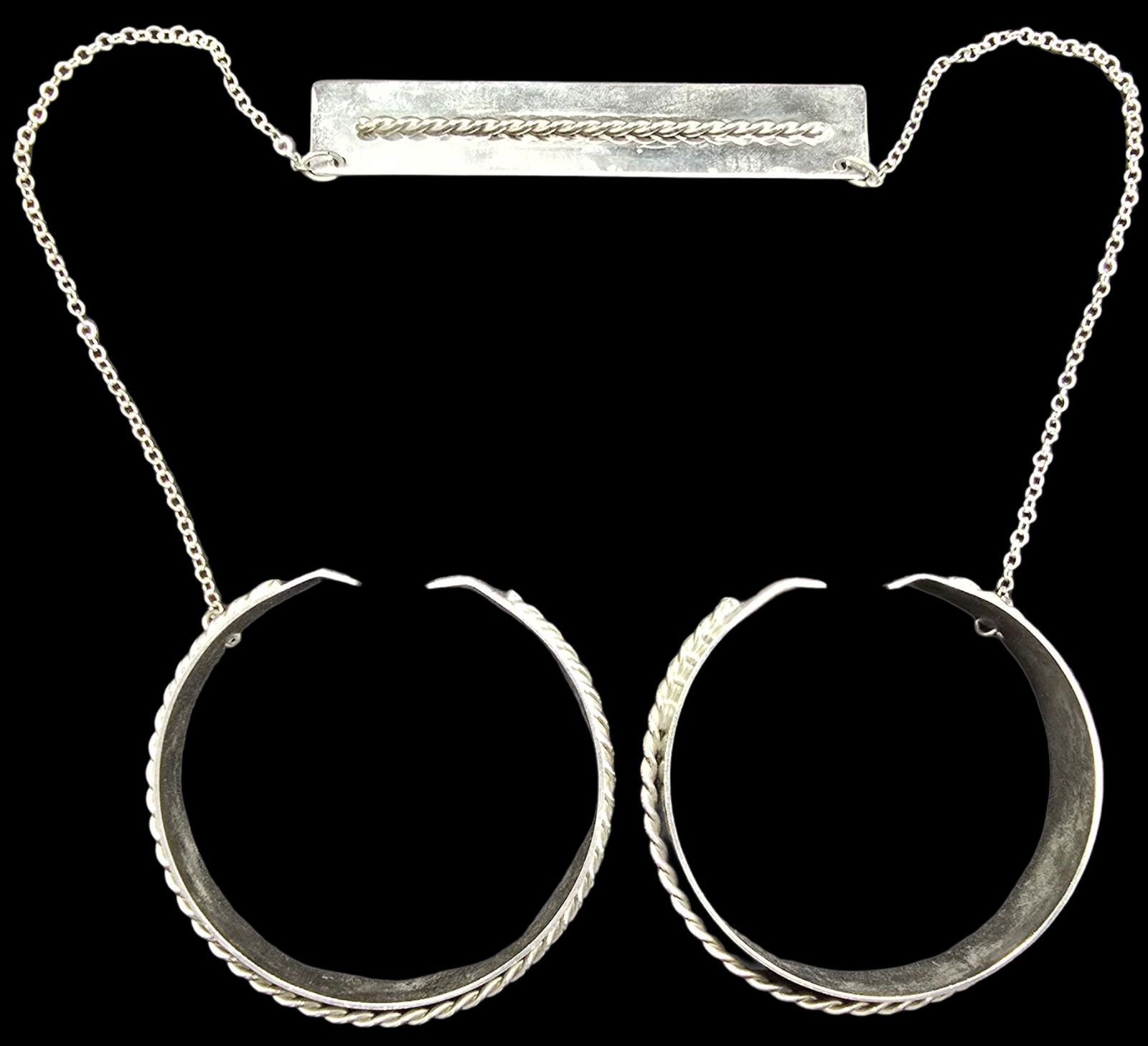 Pair of Vintage Silver-Tone Metal Costume Jewelry Bracelets: Very good vintage condition with minor patina according to age. Measures approx. 3" wide (inside diameter).