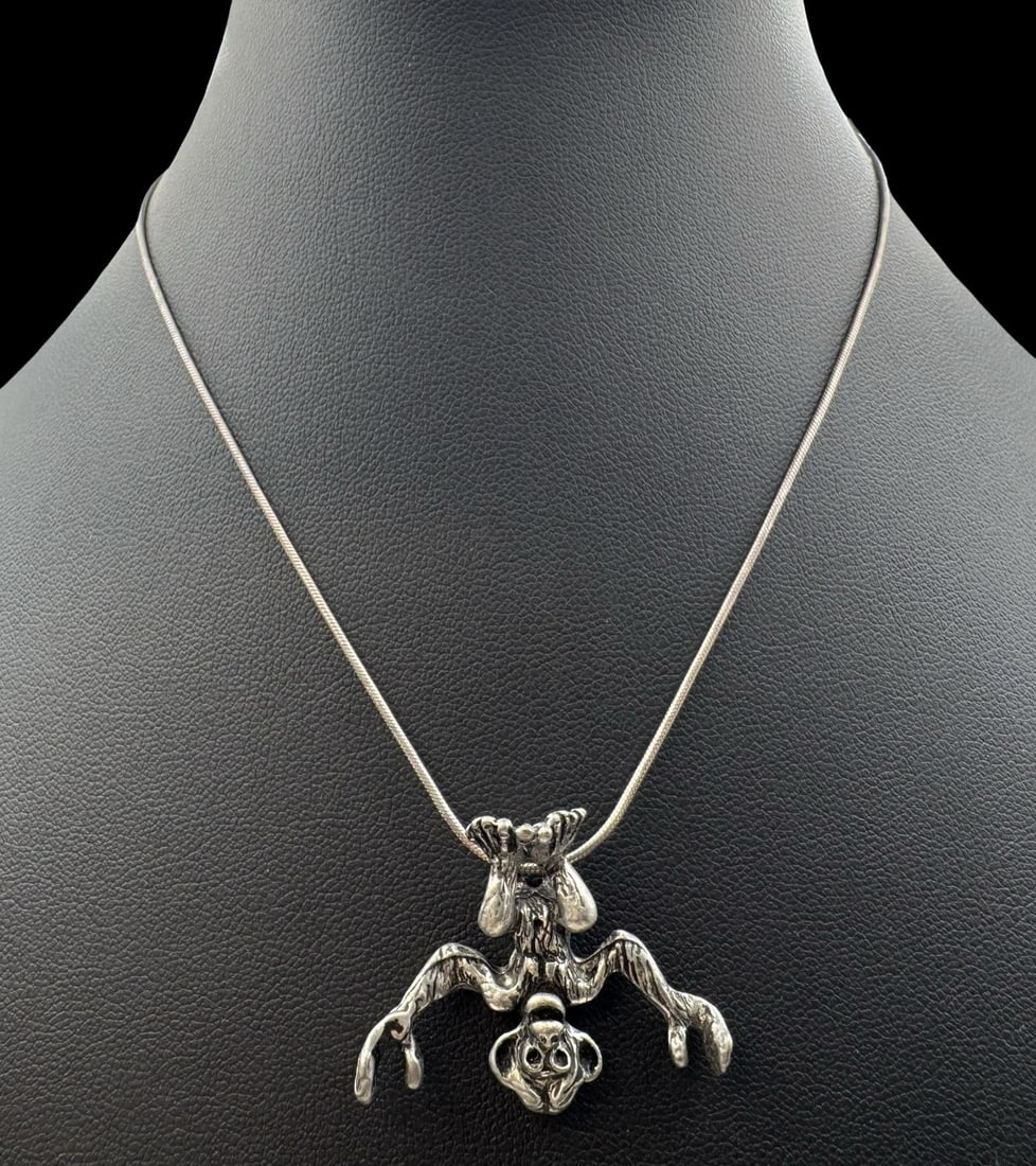 Funny Vintage Sterling Silver Upside-Down Monkey Pendant Necklace: Very good vintage condition with minor patina according to age. Pendant measures approx. 1" long x 1 1/4" wide and weighs ca. 7.3 grams. Necklace is 14" long. Marked for Sterling Silver.and carrying a