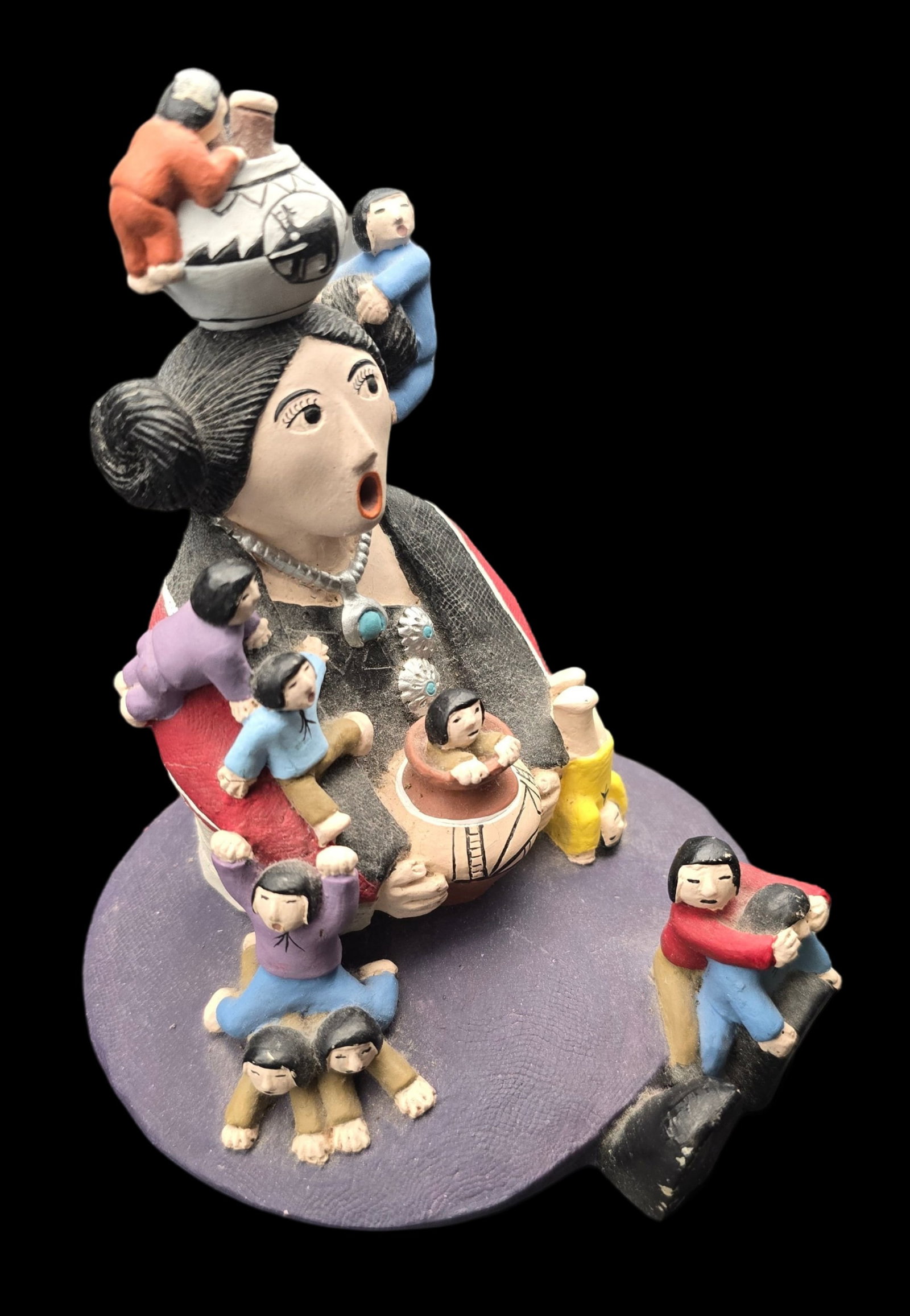 Vintage Southwestern Native American Storyteller with Children Ceramic Figurine: Measures approx. 6" high x 5" wide. Very good vintage condition with minor wear according to age. No chips, cracks, or repairs.