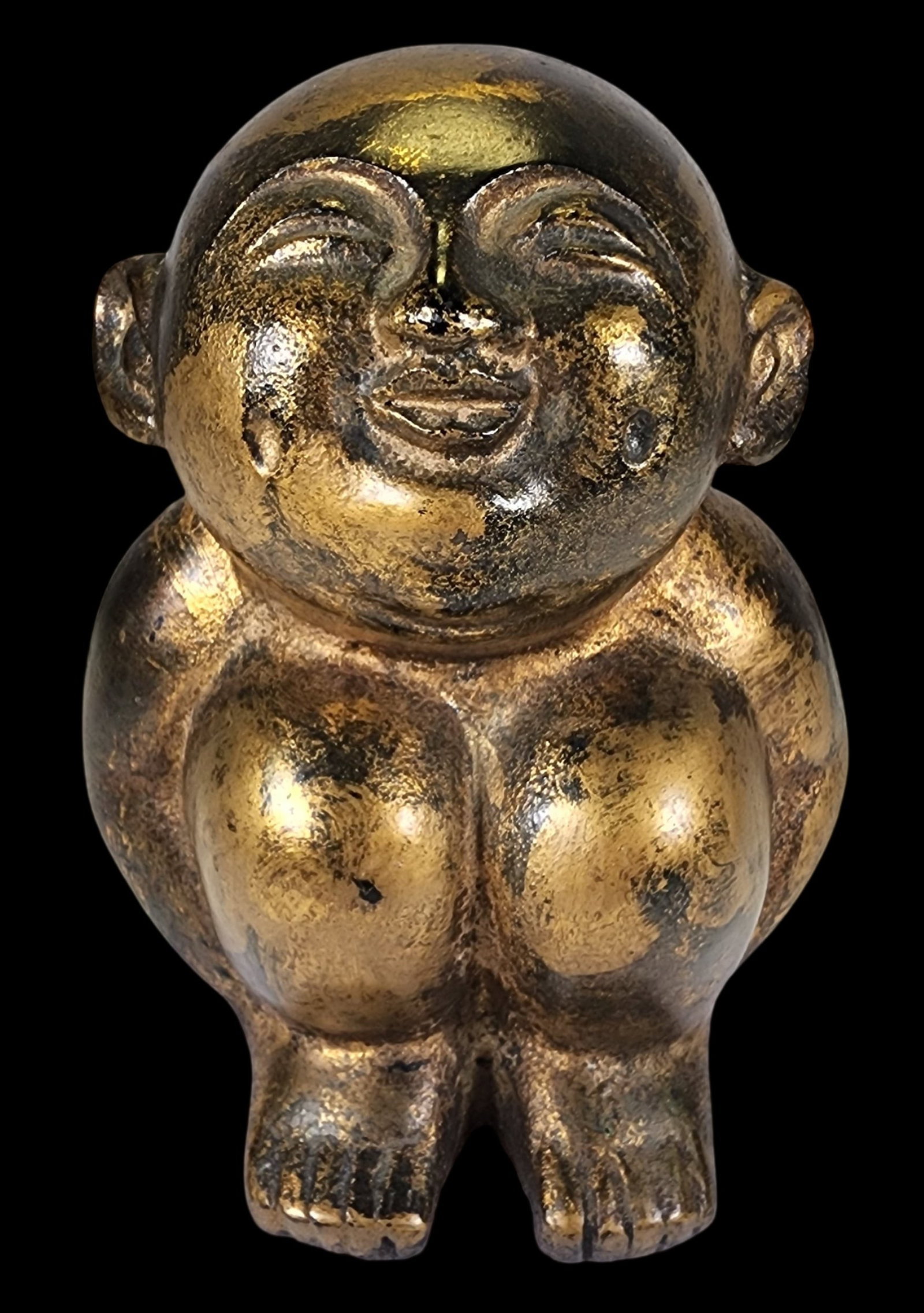 Vintage Mid-Century Japanese Gold Painted Metal Laughing Buddha / Smiling Baby Buddha Figurine: Mysterious little Buddha figure probably made from gold painted brass. Great details for a piece of this size. The facial expressions, toes, ears and double chin are fabulous. His squinty face seems c