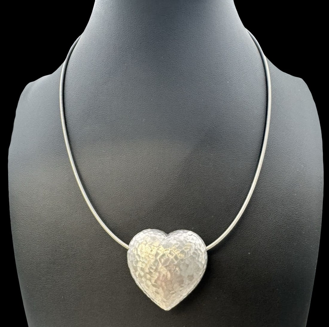 Vintage Hand Hammered Sterling Silver Heart Pendant & Stainless Steel Necklace: Very good vintage condition with minor patina according to age. Pendant measures approx. 1 5/8" long x 1 1/4" wide and weighs ca. 23.8 grams. Necklace is 18" long. Marked for Sterling Silver.