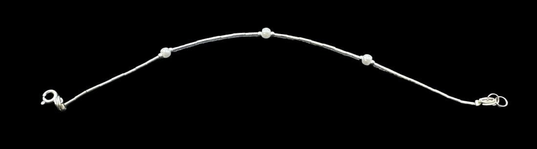 Unusual Vintage Sterling Silver & White Pearl Bracelet: Very good vintage condition with minor patina according to age. Measures approx. 7 1/2" long x 1/8" wide and weighs ca. 1.5 grams. Marked for Sterling Silver.