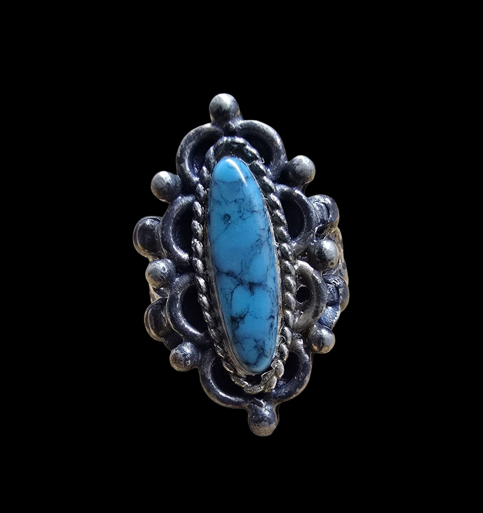 Beautiful & Ornate Vintage Navajo Native American Sterling Silver & Turquoise Ring: Very good vintage condition with minor patina according to age. The ring is a size 4 and weighs ca. 5.5 grams. Marked for Sterling Silver.