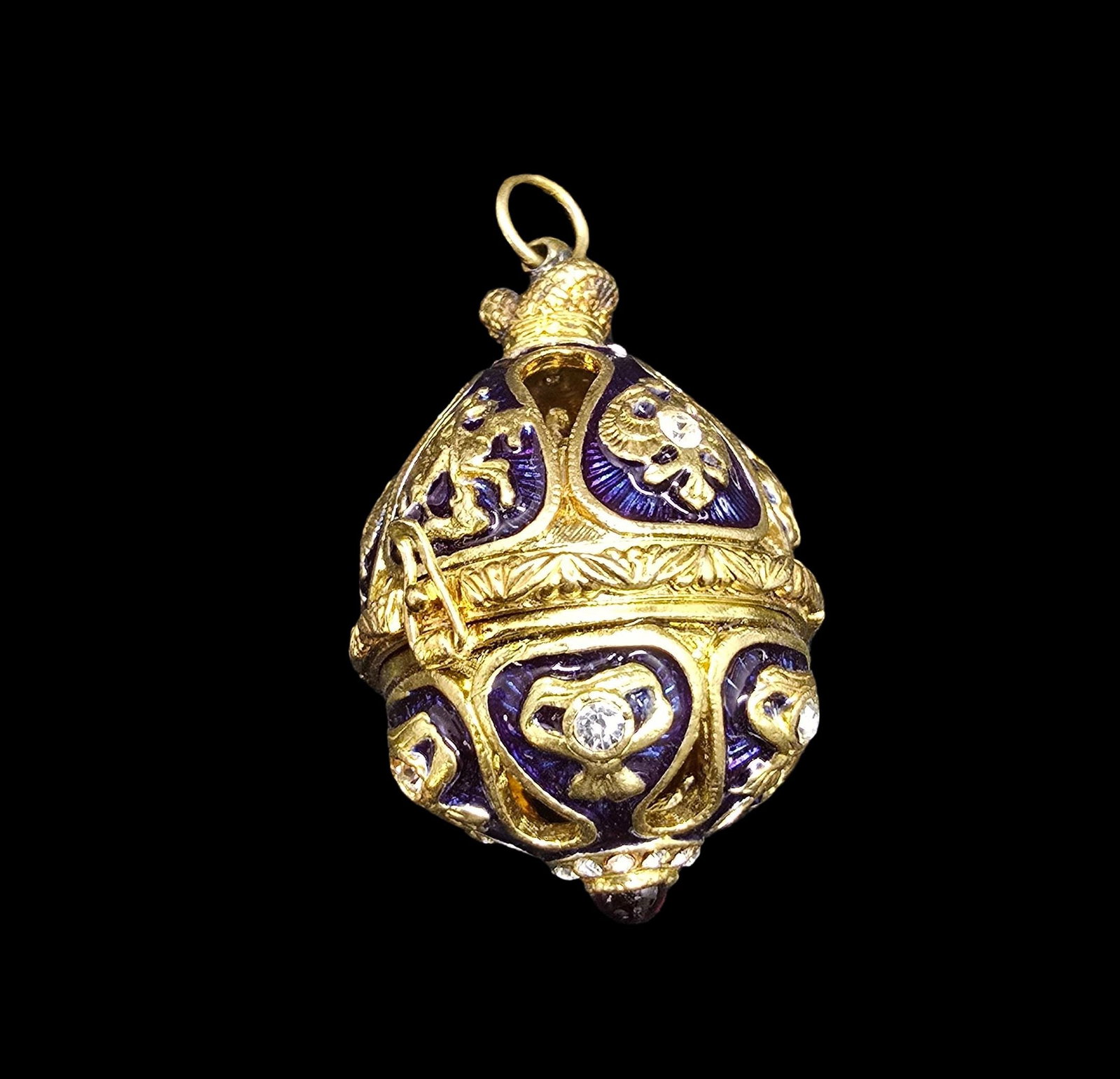 Ornate Vintage Faberge Egg Style Costume Jewelry Pendant /w Figurine Inside: Very good vintage condition with minor patina according to age. Measures approx. 1" wide and weighs ca. 35 grams.