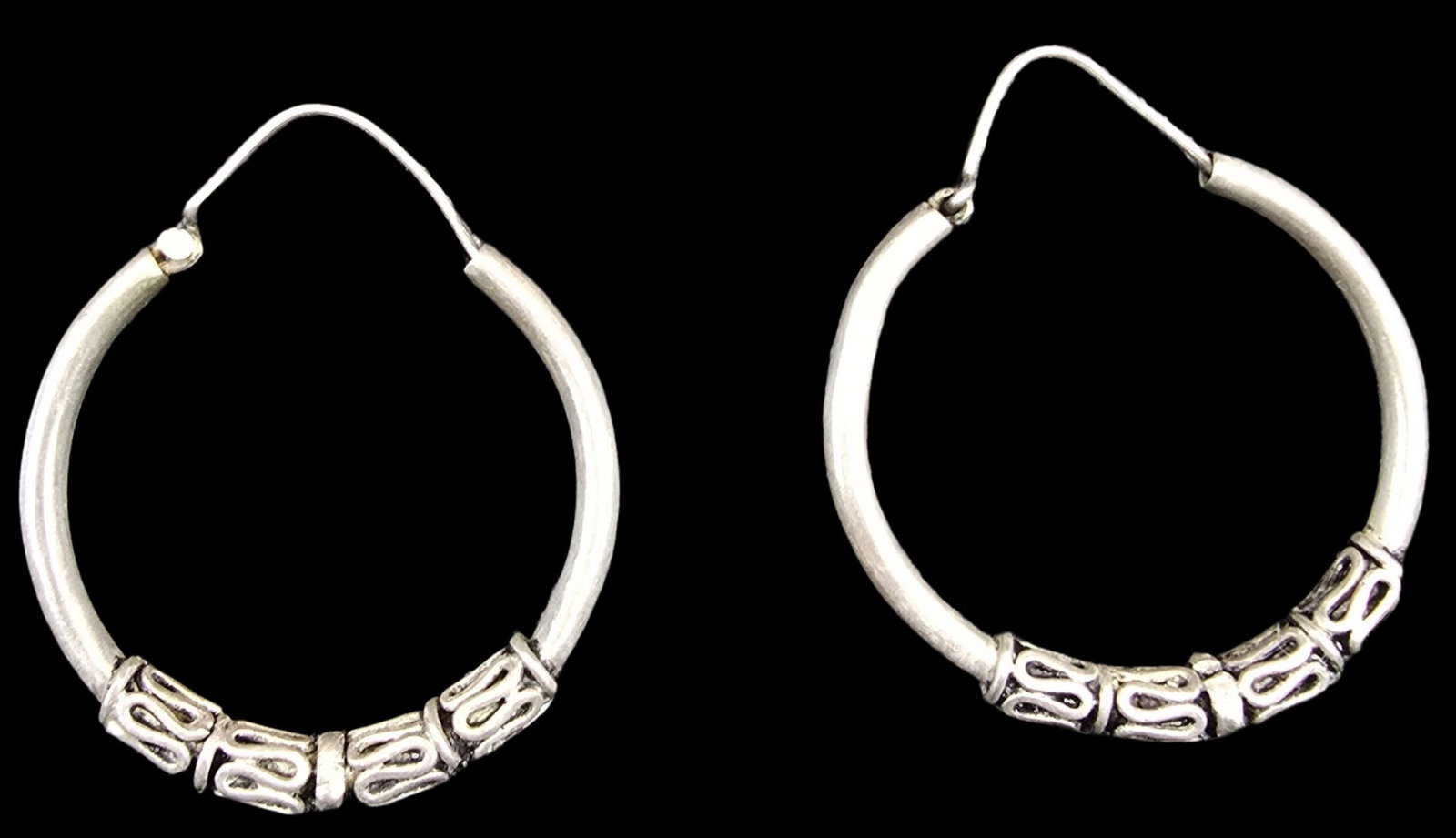 Pair of Vintage Sterling Silver Hoop Earrings: Very good vintage condition with some patina and wear according to age. Each measures approx. 1" wide and weighs ca. 2 grams.