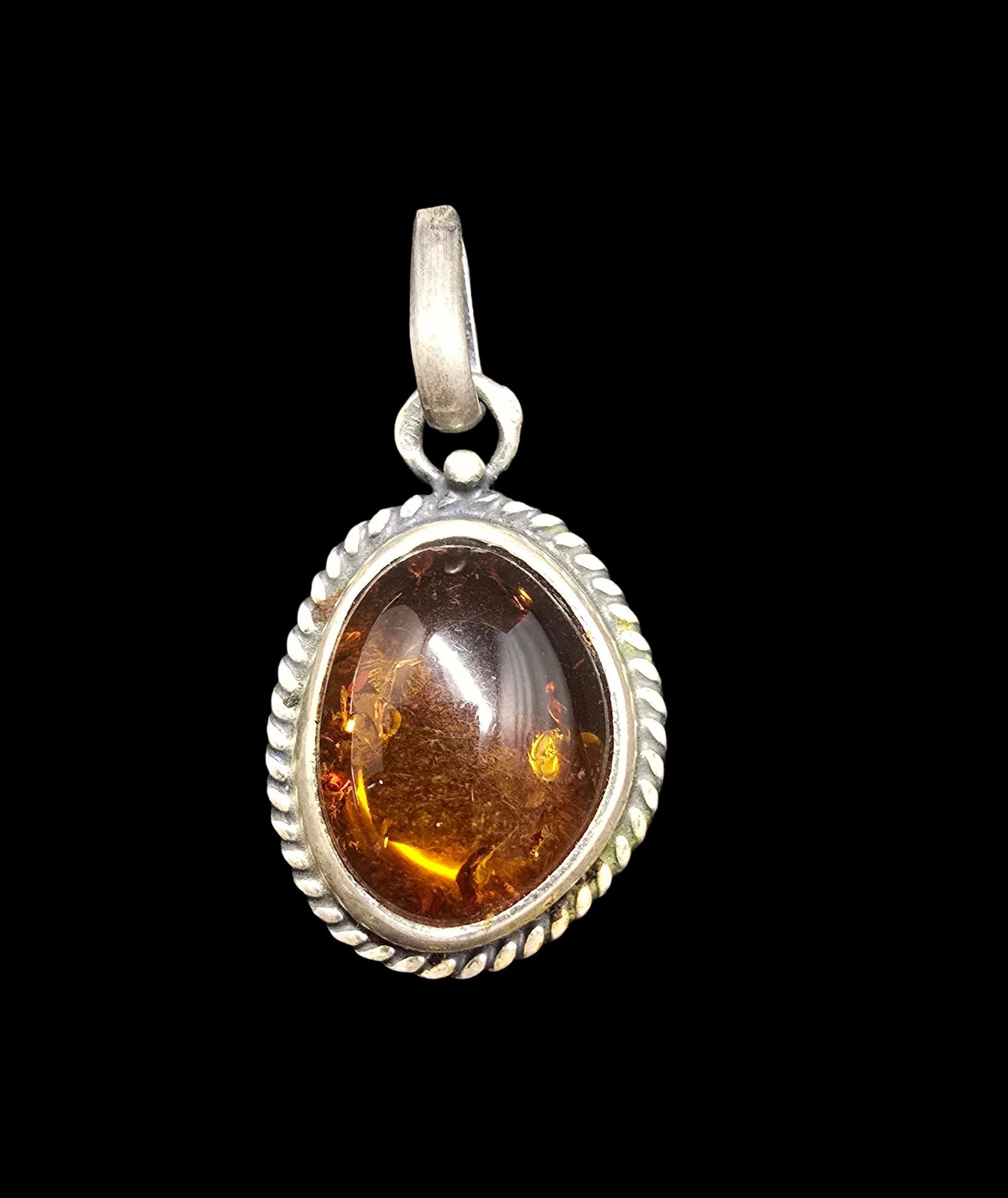 Beautiful Vintage European 800 Silver & Amber Pendant: Very good vintage condition with minor patina according to age. Measures approx. 1 1/2" long and 1" wide and weighs ca. 4.5 grams. Marked for 800 Silver.