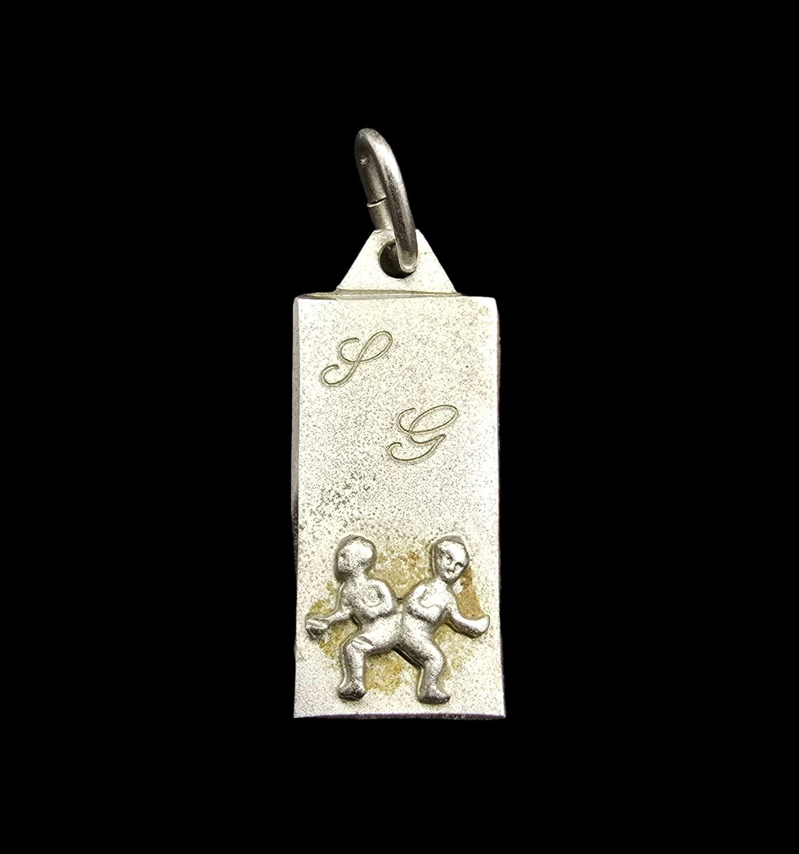 Vintage Italian Sterling Silver Zodiac Sign Gemini Pendant: Very good vintage condition with minor patina according to age. Measures approx. 1/2" wide and weighs ca. 1 gram. Marked for Sterling Silver.