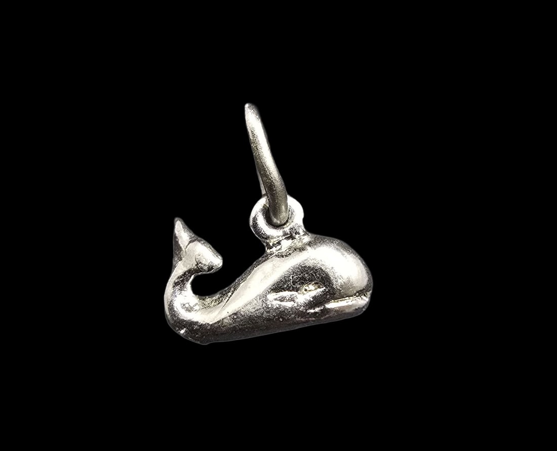 Whimsical Vintage Sterling Silver Whale Pendant Charm: Very good vintage condition with minor patina according to age. Measures approx. 1/2" long and 1/2" wide and weighs ca. 1 grams. Tested for Sterling Silver.