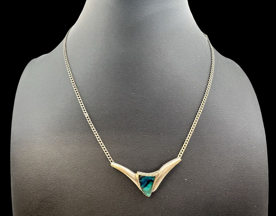 Vintage Sterling Silver & Mother of Pearl Designer Pendant Necklace: Very good antique condition with minor patina according to age. The pendant measures approx. 1 5/8" long x 1" wide and the piece has a total weight of ca. 7.7 grams. The necklace is approx. 16 1/2" lo