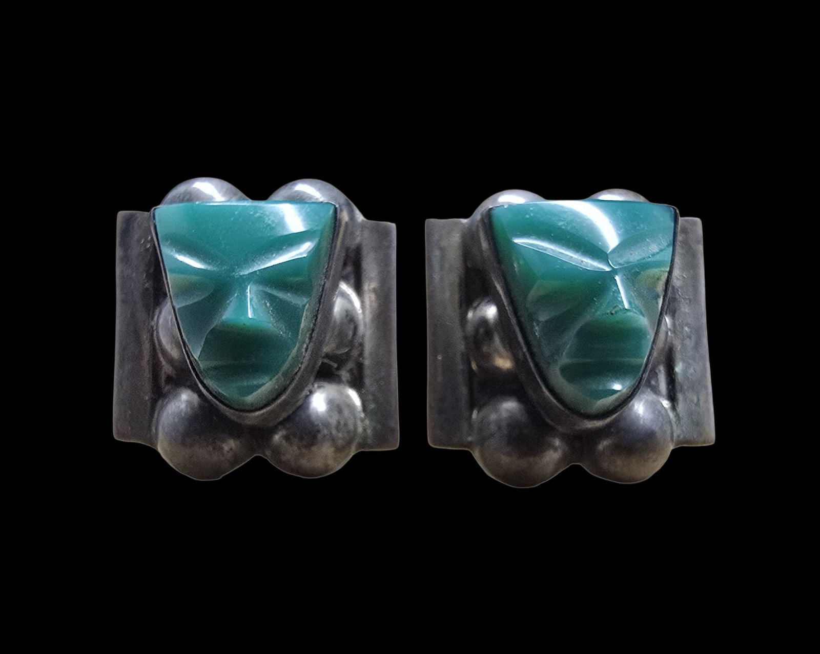 Unusual Vintage Mexican Sterling Silver & Carved Green Gemstone Face Earrings: Very good vintage condition with minor patina according to age. Each measures approx. 1" wide and they jointly weigh ca. 7.5 grams. Marked for Sterling Silver.