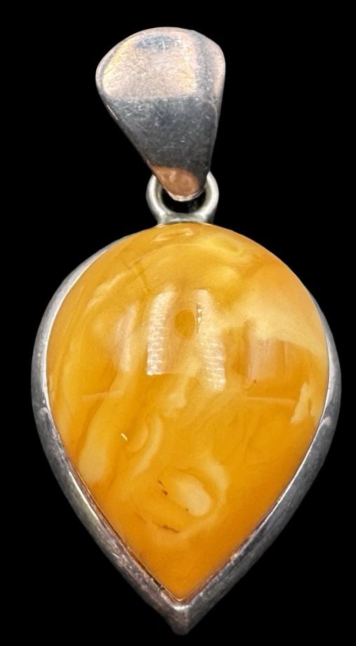Vintage Eastern European or Russian Sterling Silver Butterscotch Amber Pendant: Very good vintage condition with minor patina according to age. Measures approx. 1 3/4" long x 3/4" wide and weighs ca. 9.5 grams. Marked for Sterling Silver..