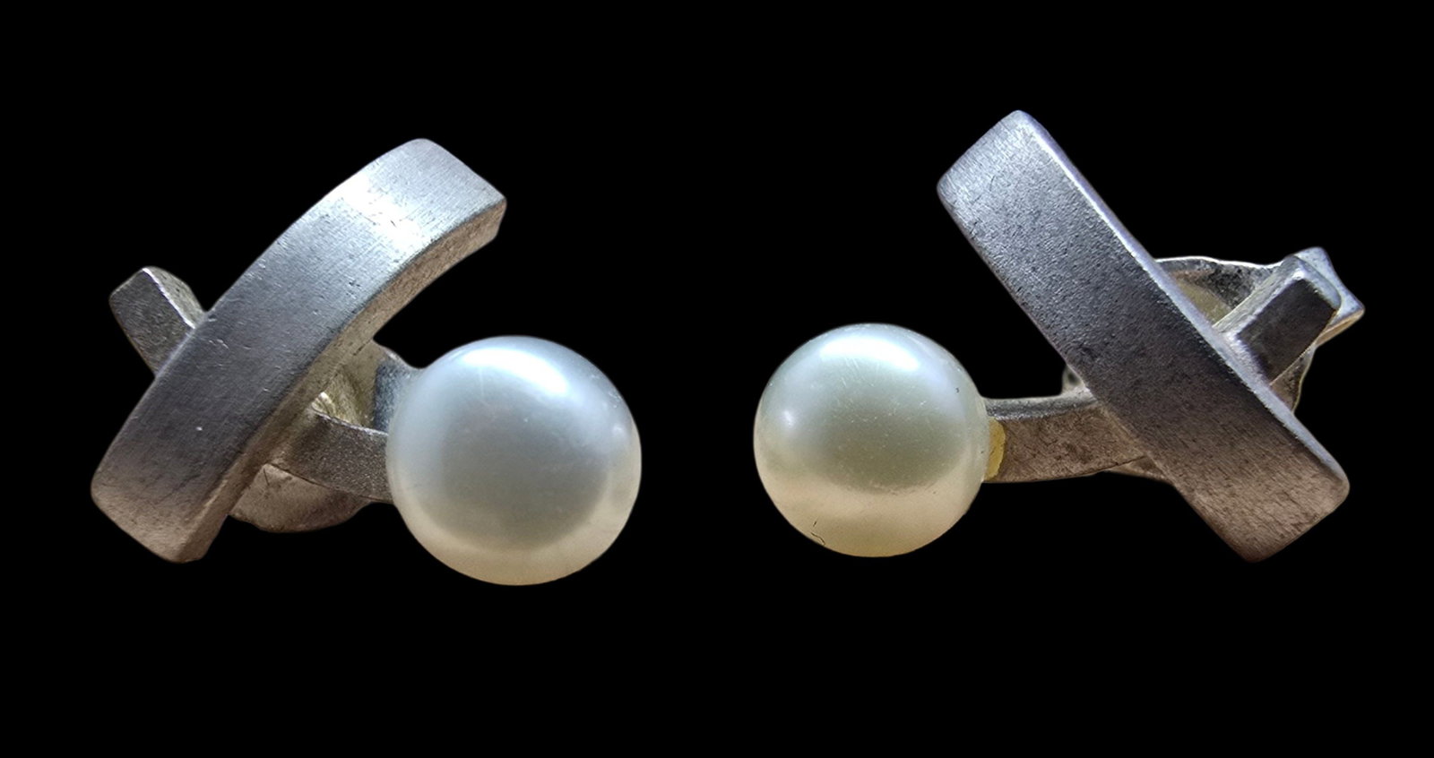 Beautiful Pair of Vintage Sterling Silver & White Pearl Earrings: Very good vintage condition with minor patina according to age. Each measures approx. 1/2" long x 1/2" wide and they jointly weigh ca. 2.5 grams. Marked for Sterling Silver.