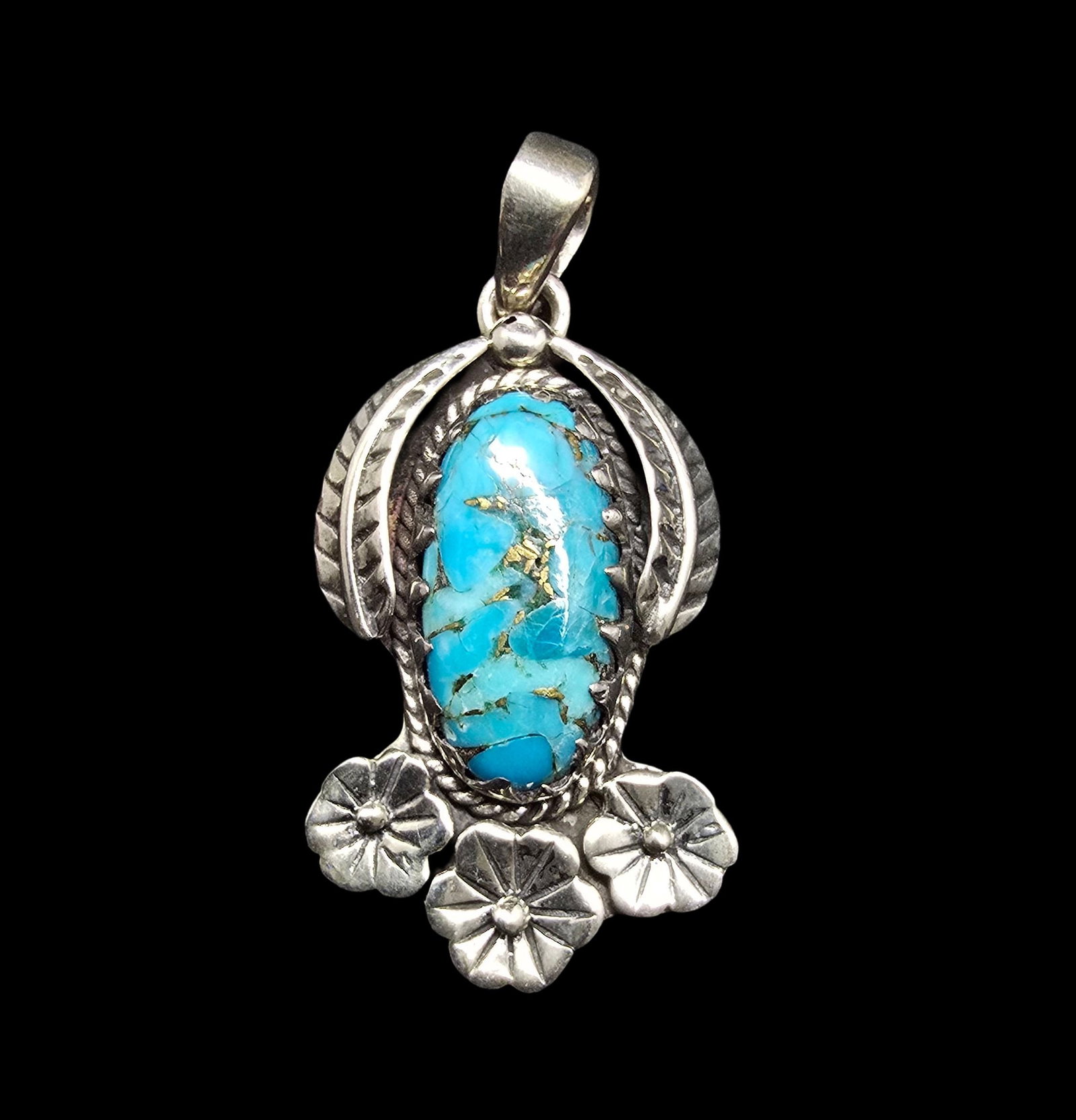 Beautiful Ornate Vintage Native American Sterling Silver & Turquoise Pendant: Very good vintage condition with minor patina according to age. Measures approx. 1 1/2" long and 1/2" wide and weighs ca. 7 grams. Marked for Sterling Silver.