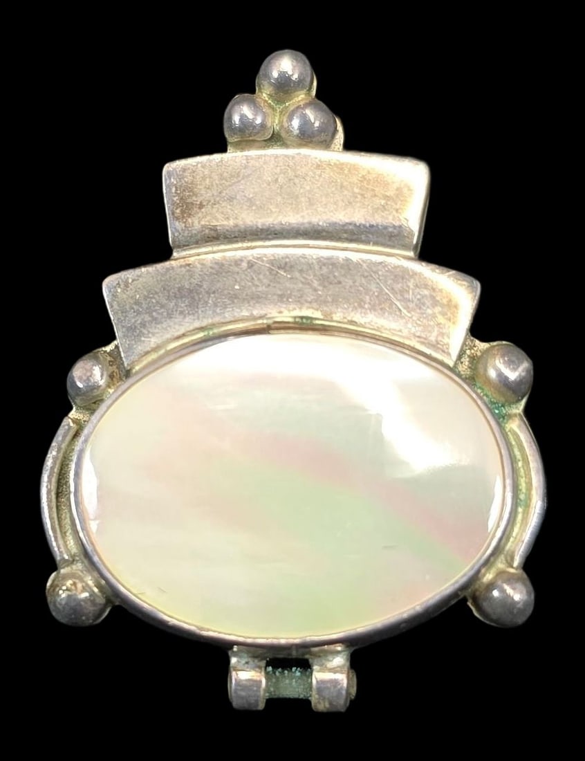 Vintage Modernist Sterling Silver & Mother of Pearl Pendant: Very good vintage condition with minor patina and wear according to age. Measures approx. 1" high and weighs ca. 11 grams. Tested for Sterling Silver.