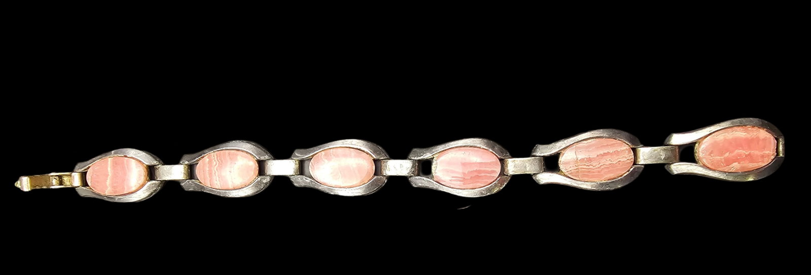 Vintage Mid-Century Modern European 835 Silver & Rhodochrosite Bracelet: Good vintage condition with some patina and wear according to age; crack to one of the gemstones. Measures approx. 7 1/2" wide and weighs ca. ca. 29.4 grams. Marked for 835 (83.5%) silver.