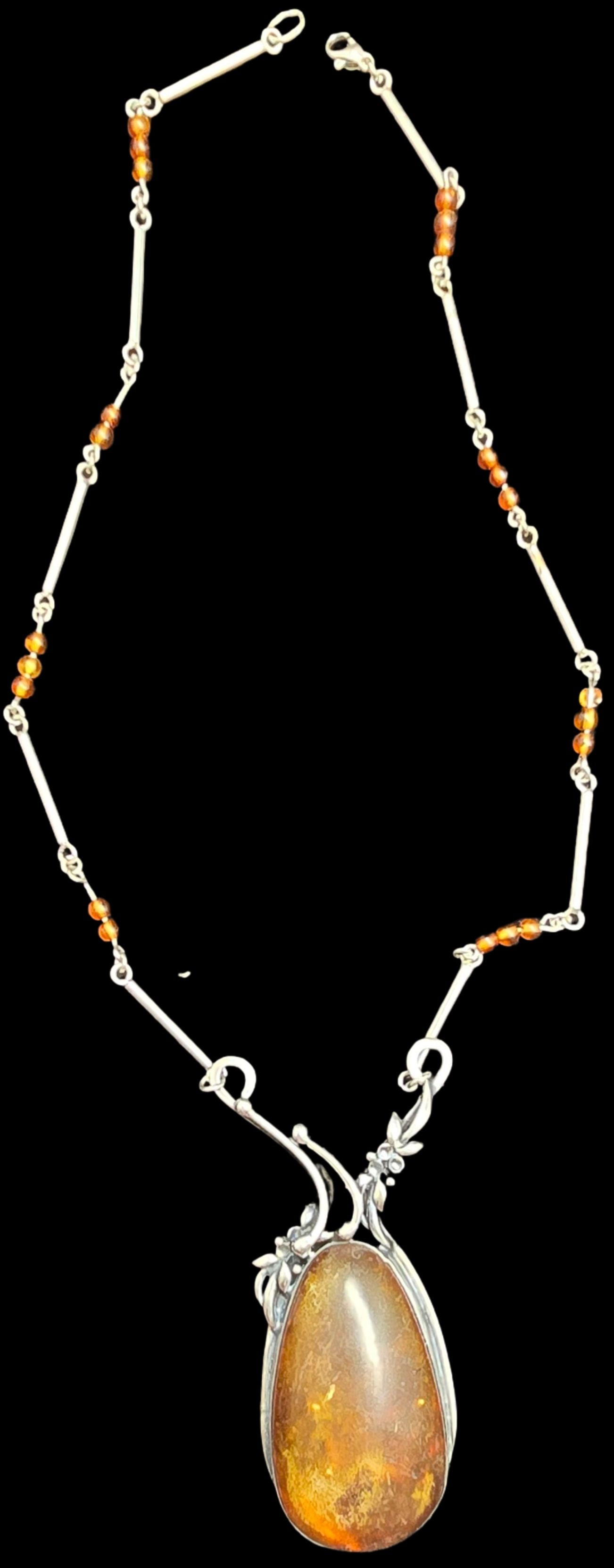 Gorgeous Vintage Sterling Silver & Baltic Amber Pendant Necklace: Very good vintage condition with minor patina according to age. Measures approx. 24" long and weighs ca. 43.5 grams. Tested for Sterling Silver.