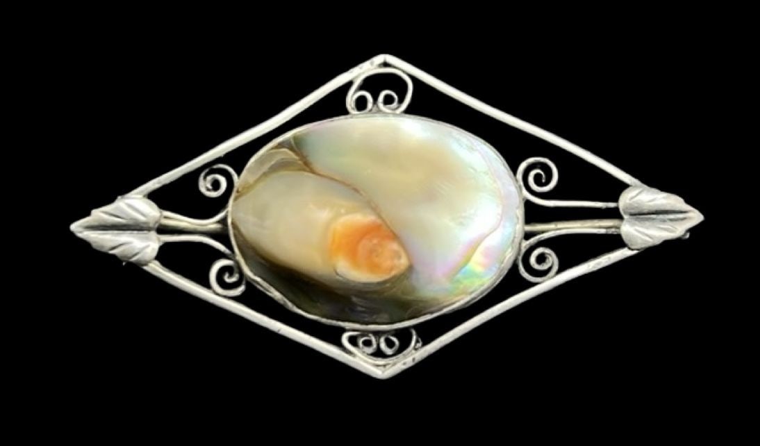 Gorgeous Ornate Vintage Sterling Silver & Abalone Shell Brooch: Very good vintage condition with minor patina according to age. Measures approx. 1 1/2" long and 7/8" wide and weighs ca. 4.3 grams. Marked for Sterling Silver.