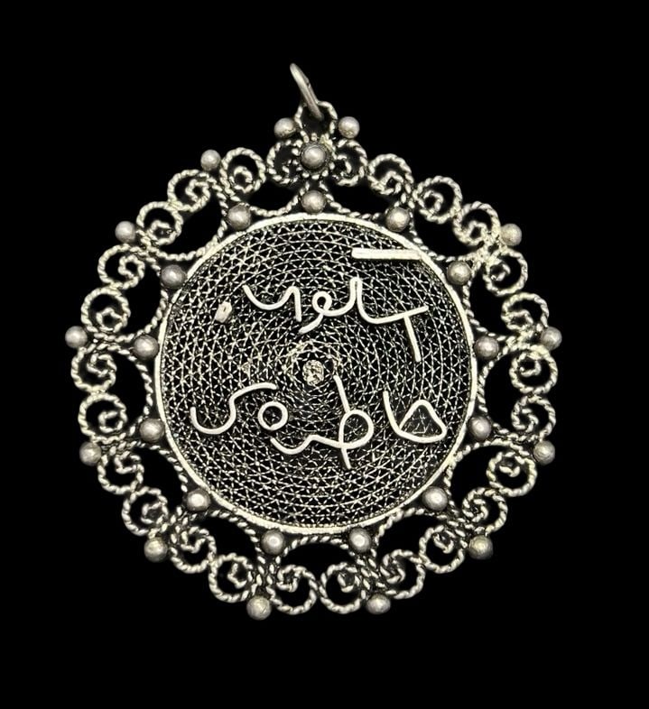 Beautiful Ornate Antique ca. 1910 African Filigree Sterling Silver & Arabic Writing Pendant: Very good antique condition with minor patina according to age. Measures approx. 1 1/8" long and 1 1/8" wide and weighs ca. 10.7 grams. Marked for Sterling Silver.