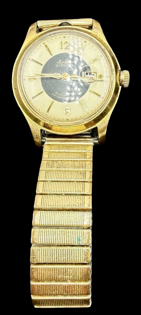 Vintage ANKER Stainless Steel Gold Tone /w 21 Rubis Watch: Very good vintage condition with minor patina according to age. Dial measures approx. 1" long and 1" wide and weighs ca. 59.43 grams. Marked for ANKER. The timepiece is working and features an elastic