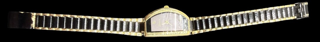 Vintage GENEVA Stainless Steel Gold, Black Tone & Quartz Ladies Watch: Very good vintage condition with minor patina according to age. Dial measures approx. 1" long and 3/4" wide and weighs ca. 30.13 grams. Marked for GENEVA. The timepiece is currently not working.