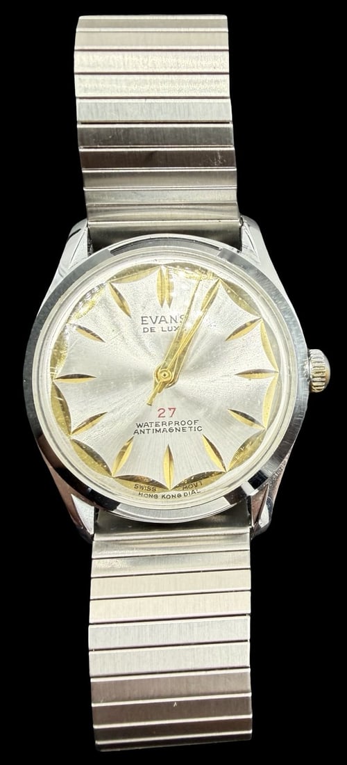 Vintage EVANS De Luxe Stainless Steel Gold Tone Ladies Watch: Very good vintage condition with minor patina according to age. Dial measures approx. 1 1/4" long and 1 1/4" wide and weighs ca. 55.19 grams. Marked for EVANS. The timepiece is currently not working a