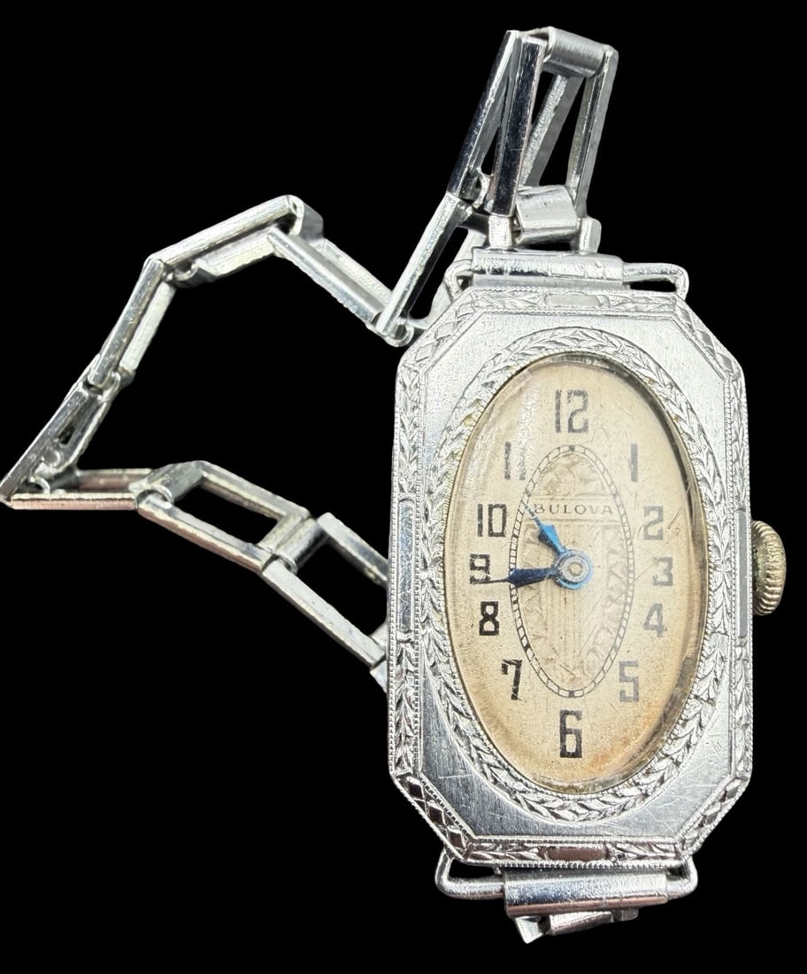Vintage BULOVA Silver Tone & Beige Dial Ladies Watch: Very good vintage condition with minor patina according to age. Dial measures approx. 1" long and 1/2" wide and weighs ca. 16.42 grams. Marked for BULOVA. The timepiece is currently not working.