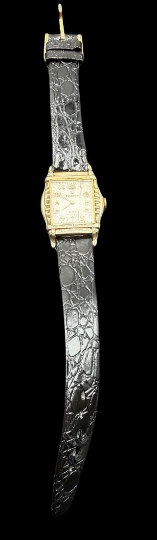 Vintage Mid-Century HELBROS Gold Filled & Black Leather Strap Wristwatch: Very good vintage condition with minor patina according to age. Dial measures approx. 3/4" long and 3/4" wide and weighs ca. 27.01 grams. Marked for HELBROS. The timepiece is currently not working.