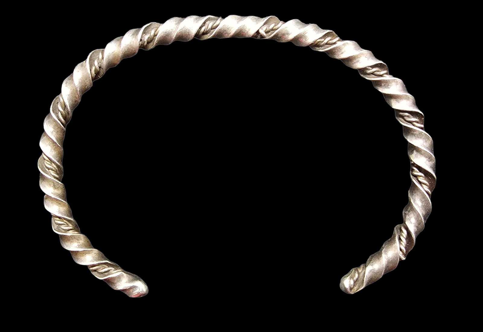 Stylish Vintage Sterling Silver Twisted Cable Cuff Bracelet: Very good vintage condition with minor patina according to age. Measures approx. 2 1/2" wide (inside diameter) and weighs ca. 11.5 grams. Tested for Sterling Silver.