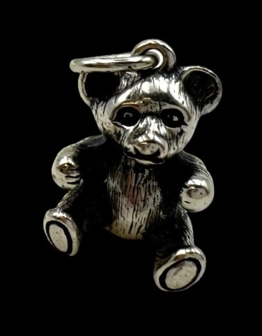 Vintage Sterling Silver Teddy Bear Pendant Charm: Very good vintage condition with minor patina according to age. Measures approx. 3/4" long x 3/8" wide and weighs ca. 6.6 grams. Marked for Sterling Silver.and carrying an unidentified designer mark.