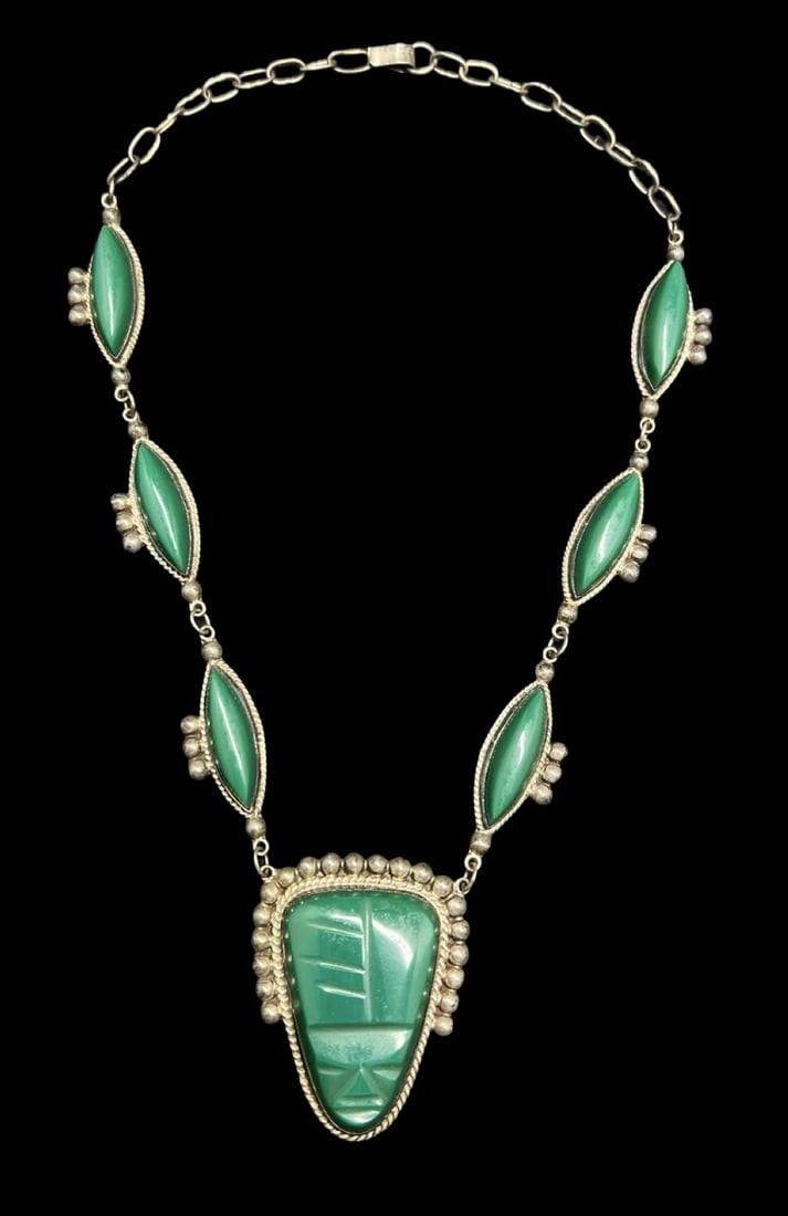 Stunning Ornate Vintage TAXCO Mexico Sterling Silver & Green Gemstone Carved Face Pendant Necklace: Very good vintage condition with minor patina according to age. Pendant measures approx. 2" long and 1 5/8" wide and the entire piece weighs ca. 56.7 grams. Necklace is 10" long and 5/8" wide. Marked 