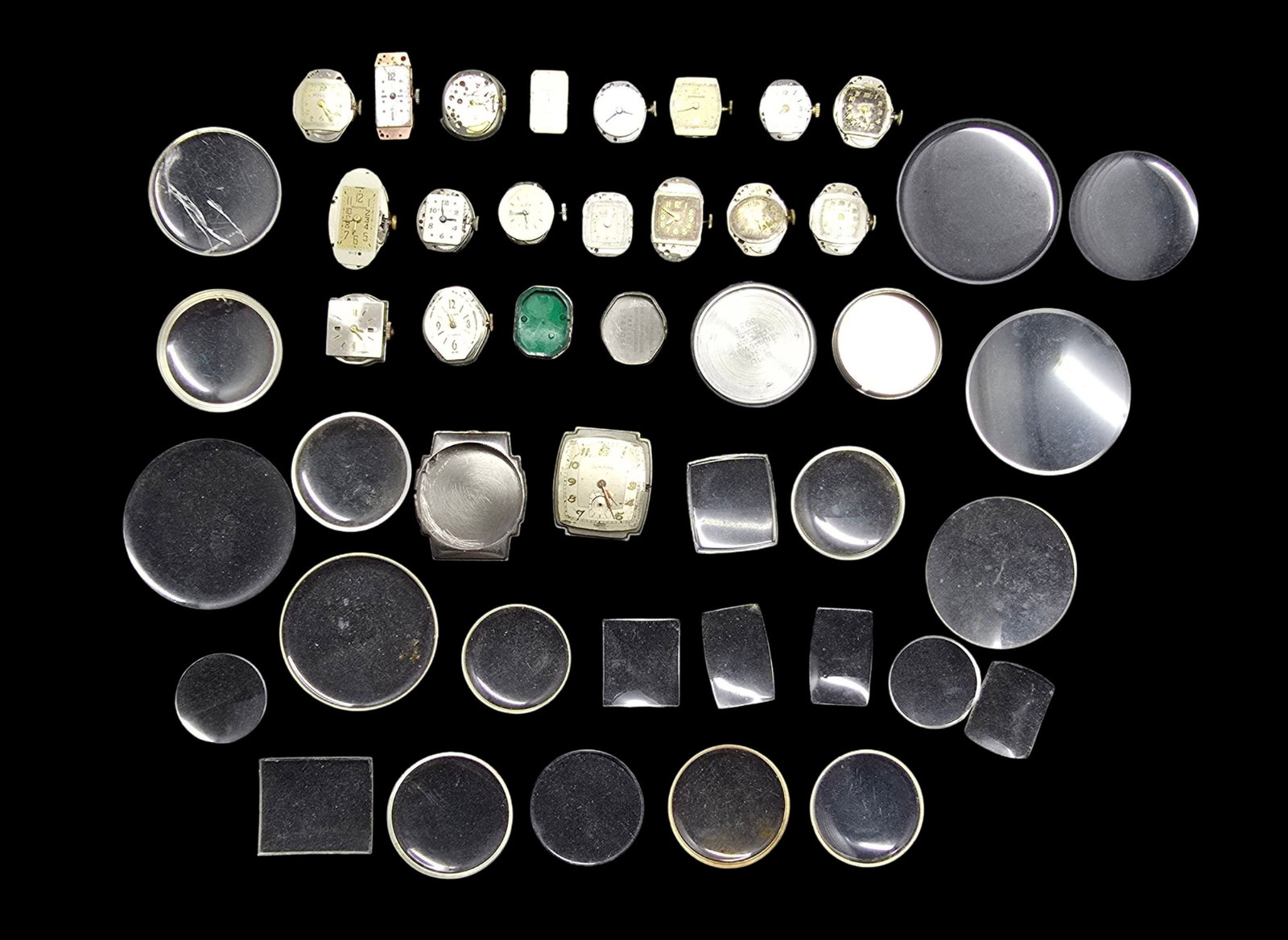 Large Lot of Watch Movements & Watch Parts: Very good vintage condition with minor patina according to age. The largest piece measures approx. 1" high and 1" wide and the entire lot weighs ca. 80 grams.